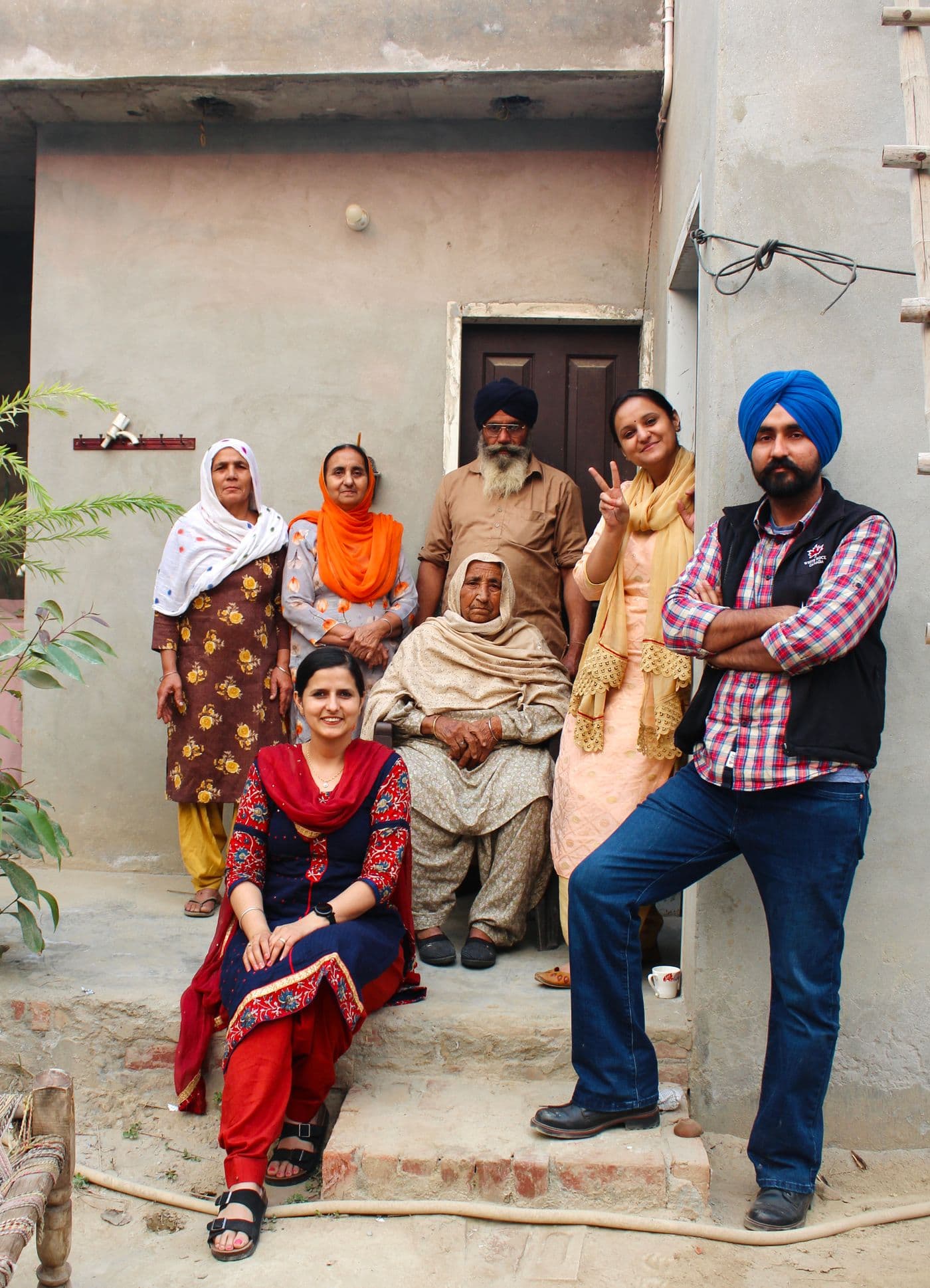 Indian family outside their home powered by rooftop solar