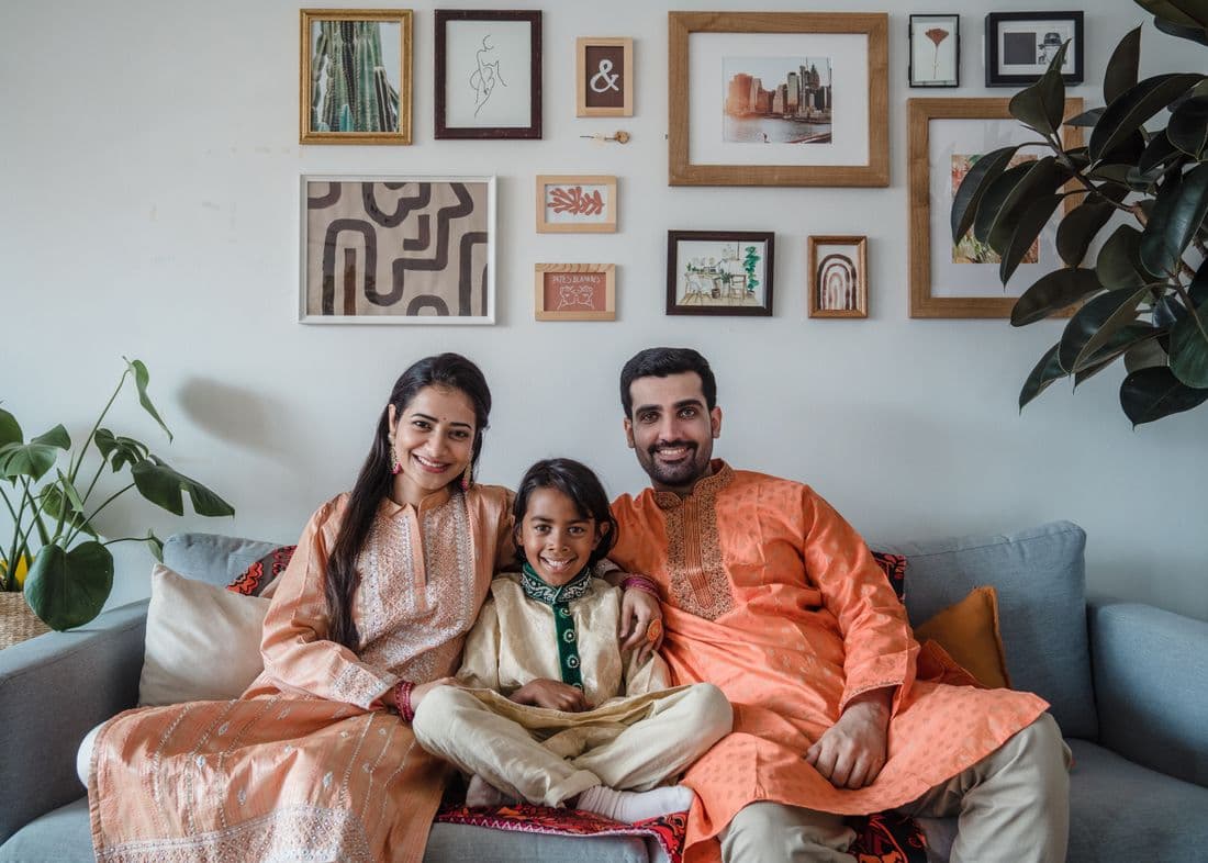 Happy Indian family at home after going solar with Brightly.Solar