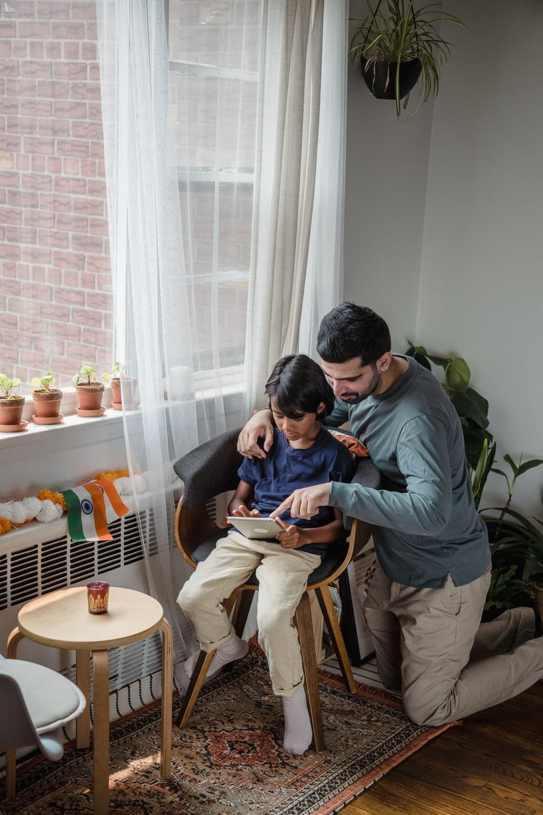 Indian father and son reviewing their solar savings at home